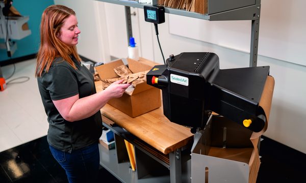 Freshly dispensed ProPad paper pad being taken at an open carton