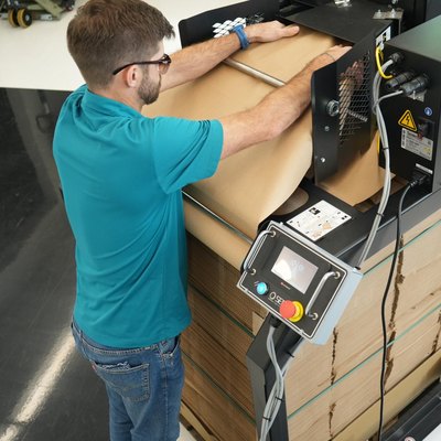 Employee feeding the endless paper upright into the ProPad Horizontal